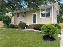 Charming single-story home with brick facade, well-maintained landscaping, and inviting front yard at 1481 Woodview Ln, Charleston, SC 29412