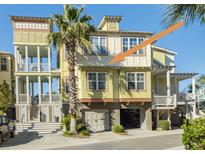 Charming multi-story home showcasing a well-maintained exterior with a garage and lush landscaping at 204 Michigan Ave # C-5 - 11, Folly Beach, SC 29439