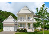 Charming two-story home with a double porch, white siding, and a well-manicured front yard at 2828 Wagner Way, Mount Pleasant, SC 29466