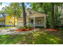 Charming home featuring a lovely front porch, well-maintained lawn, and an attached garage at 3005 Macbeth Creek Dr, Charleston, SC 29414