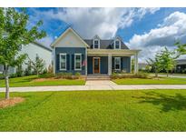 Charming two-story home with well-manicured lawn and a welcoming front porch at 436 Ripple Park Dr, Summerville, SC 29486