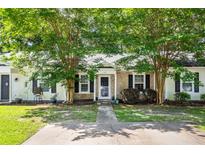 Charming single-story home with brick facade, black shutters, and inviting landscaping at 102 Sandy Hook Ct, Summerville, SC 29486