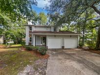 Charming two-story home featuring a two-car garage, landscaped yard, and a welcoming front entrance at 109 Evance Ct, Summerville, SC 29485