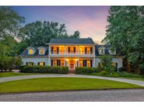 Elegant two-story home featuring a welcoming porch and beautifully landscaped front yard at 115 Old Postern Rd, Summerville, SC 29483