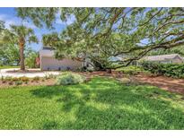 Charming home featuring lush green lawn, mature trees, and an inviting curb appeal at 1199 Parkway Drive, Mount Pleasant, SC 29464