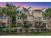 Charming townhome exterior with a beautiful landscape, garage, palm trees, and great curb appeal at 1253 Dingle Rd, Mount Pleasant, SC 29466