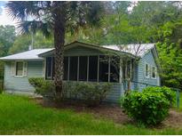 Charming home featuring a screened porch and lush landscaping at 126 Rattlensnake Trl, Walterboro, SC 29488