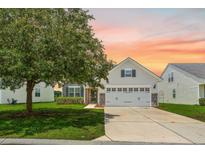 Charming single Gathering home featuring a two-car garage, stone accents, and a well-manicured lawn at sunset at 199 Decatur Dr, Summerville, SC 29486