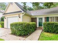 Charming home featuring a well-manicured lawn, a garage, and a welcoming front door with green shutters at 202 Chandler Dr, Ladson, SC 29456