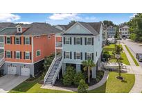 Charming raised beach home featuring a boat, two-story design and inviting staircase at 307 Morning Marsh Ln, Charleston, SC 29492