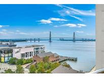 Stunning city view featuring a beautiful harbor and bridge on a bright, sunny day at 330 Concord St # 12C, Charleston, SC 29401