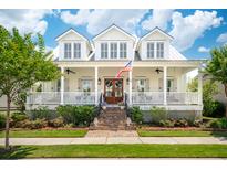 Charming two-story home with a brick staircase and a welcoming front porch beneath a bright blue, partly cloudy sky at 371 Bridgetown Pass, Mount Pleasant, SC 29464