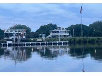 Charming waterfront property features a private dock and stunning views of the water at 4352 Bream Rd Rd, North Charleston, SC 29418