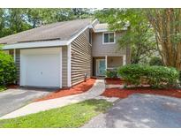 Inviting exterior showcasing the home's two-story layout, attached garage, and well-manicured front yard at 4752 Trailside Ct # B, North Charleston, SC 29418