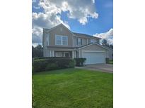 Charming two-story home featuring a well-manicured lawn, and a two car garage at 7164 Sweetgrass Blvd, Hanahan, SC 29410