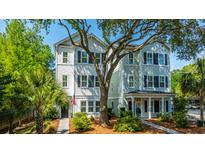 Charming two-story home with a landscaped yard and a welcoming front porch, great for relaxing and enjoying the neighborhood at 977 Warrick Oaks Ln, Mount Pleasant, SC 29464