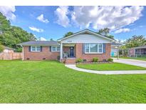Charming brick home with a well-manicured lawn and walkway leading to the front door at 108 Reardon St, Moncks Corner, SC 29461