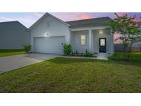 Charming home featuring a well-maintained lawn, attached garage, and cozy front porch at 109 Lyra Ln, Summerville, SC 29486