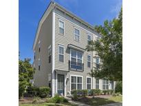 Charming townhome featuring neutral siding, a small balcony, and well-maintained landscaping at 1543 Bluewater Way, Charleston, SC 29414