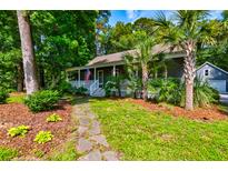Charming home with inviting front porch, lush landscaping, and stone pathway leading to the entrance at 1872 Staffwood Rd, Johns Island, SC 29455