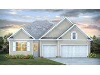 Charming one-story home featuring a three-car garage, well-manicured lawn, and beautiful landscaping at 214 Bilge Rd, Ridgeville, SC 29472