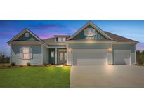 Charming coastal home with a two-car garage and a well-manicured lawn at 215 Bilge Rd, Ridgeville, SC 29472