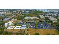 Scenic aerial view of building exteriors, parking, waterways and bridges in a coastal community at 225 Seven Farms Dr # 307, Daniel Island, SC 29492