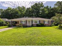 Charming brick home with well-maintained lawn and mature trees, located in a desirable neighborhood at 344 Canterbury Rd, Charleston, SC 29407