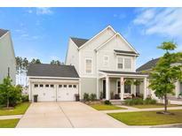 Charming two-story home featuring a welcoming front porch and a convenient two-car garage at 347 Ripple Park Dr, Summerville, SC 29486