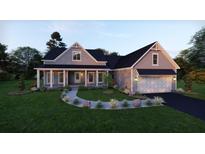 Charming two-story home with a covered porch, manicured lawn, lush landscaping, and a two car garage at 4848 Woodville Rd, Awendaw, SC 29429