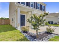 Inviting home entrance featuring a navy front door, manicured landscaping, and a welcoming aesthetic at 494 Pender Woods Dr, Summerville, SC 29486