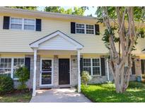 Charming townhome with a well-maintained lawn, brick facade, black shutters, and inviting entranceway at 507 Stinson Dr # 4G, Charleston, SC 29407