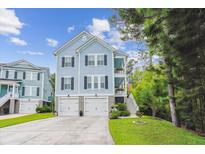 Charming two-story home with a two-car garage, blue siding, and a well-manicured lawn at 542 Amalie Farms Dr, Charleston, SC 29492