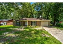 Charming brick home with a well-manicured front yard and mature trees at 610 Old Golf Rd, Summerville, SC 29483