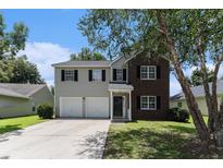 Charming two-story home with a two-car garage and a well-manicured front yard at 8044 Old London Rd, North Charleston, SC 29406