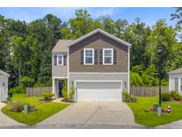 Charming two-story home featuring a neat lawn, a two-car garage, and lovely curb appeal at 9808 Wooden Pestle Way, Ladson, SC 29456