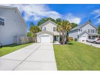 Charming two-story home featuring a manicured lawn, garage, and beautiful landscaping at 105 Lovette Ct, Goose Creek, SC 29445