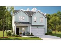 Charming two-story home featuring a light blue exterior, a two-car garage, and a cozy front porch at 115 Pen Shell St, Summerville, SC 29485