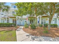 Charming two-story condo with light-blue siding, manicured bushes, and a welcoming front entrance at 1723 Brittlebush Ln, Johns Island, SC 29455