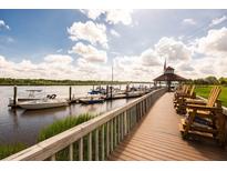 Scenic marina view with boardwalk, gazebo and multiple boats docked on the water at 2329 Tall Sail Dr # 704D, Charleston, SC 29414