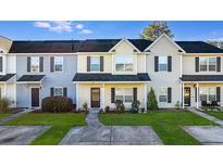 Inviting townhome featuring a well-maintained lawn and charming outdoor seating at 282 Swallowtail Ln, Goose Creek, SC 29445