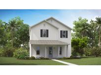 Charming two-story home with white siding, a covered porch, and lush landscaping at 304 Archar St, Summerville, SC 29486