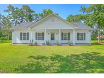 Charming single-story home features white siding, black shutters, and a welcoming front porch at 326 Turner Ln, Round O, SC 29474