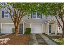 Charming townhome exterior with a private entrance and attached garage at 4028 Babbitt St, Charleston, SC 29414