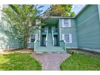 Inviting exterior view of the home featuring a charming entryway and well-maintained lawn at 6280 Rolling Fork Rd # 302, North Charleston, SC 29406