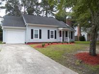 Charming single-story home featuring a garage, manicured front yard, and classic architectural details at Way, Goose Creek, SC 29445