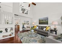 Bright living room with high ceilings, wood floors, and elegant decor at 105 Brockman Way, Goose Creek, SC 29445