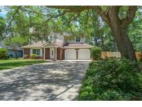 Charming two-story home boasts a brick facade, a two-car garage and a large, mature shade tree at 110 Bayberry Run, Summerville, SC 29485