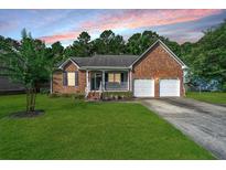 Charming brick home featuring a well-manicured lawn and an attached two-car garage at 115 W Park Ln, Summerville, SC 29486