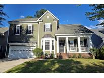 Charming two-story home features a front porch, attached garage, and beautiful landscaping at 116 Marshside Dr, Summerville, SC 29485